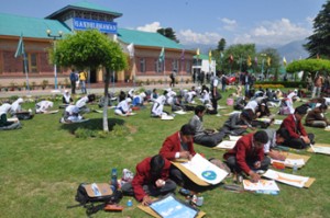 Students during Painting competition at Kashmir University on Tuesday.