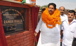 Minister for Revenue Raman Bhalla laying foundation stone for starting construction of lanes, drains at Sunjwan on wednesday.