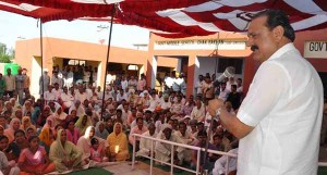 Minister for Industries and Commerce Surjit Singh Slathia addressing a gathering  at Vijaypur on Monday.