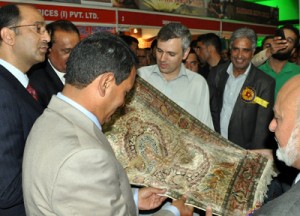 Chief Minister Omar Abdullah having a look at handicraft item during Buyer-Seller meet on Monday.