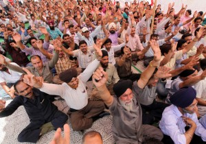 Govt employees taging protest dharna at Exhibition Ground in Jammu on Tuesday. - Excelsior/Rakesh