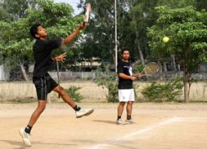 Player jumping and smashing during a semifinal match of Gulrez Memorial Lawn Tennis Tournament in Jammu on Thursday.	