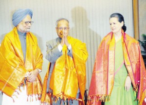 Finance Minister Pranab Mukherjee with Prime Minister Manmohan Singh and Congress president Sonia Gandhi as soon as his name was proposed for the UPA candidate for the Presidential election in New Delhi on Friday. (UNI)