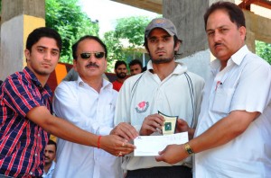 Chief guest presenting man of the match trophy to wicket-keeper batsman Manish Dogra at Sports Stadium Doda on Friday.