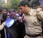 Police detaining Government employee leader Khurshad Alam Wani during a protest march in Srinagar on Wednesday. 
