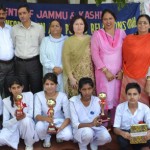 Students holding trophies while celebrating National Sports Day at Udhampur on Wednesday.