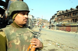 March-08, 2013-SRINAGAR: Paramilitary soldier  stands guard on a deserted street in Srinagar on Friday during curfew was imposed in kashmir valley as a precautionary measure with the authorities apprehending law and order problem following the killing of a youth in Army firing in north Kashmir’s Baramulla district. Photo/Mohd Amin War