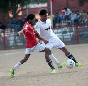 Tough tussle between footballers to get hold of the ball during a match of Christmas Soccer Championship in Jammu on Sunday.— Excelsior/ Rakesh