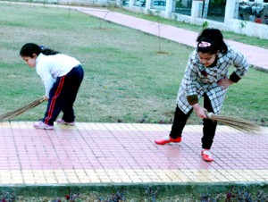 Children cleaning the public park at Channi Himmat Housing Colony.