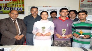 Sant Kumar Sharma, senior journalist along with Dr B.L.Gupta, Principal of the college posing for a photograph with winning students.