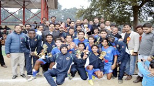 JK Bank team posing alongwith ADGP Dilbag Singh and Commissioner, Jammu Municipal Corporation after lifting 2nd Christmas Soccer Championship title in Jammu on Friday.