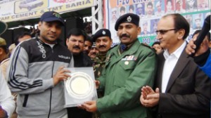 Memento being presented to International cricketer Joginder Sharma by SP Kathua, Mohan Lal during valedictory function. 