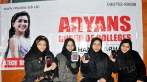 (From L to R) Zeenat, Yusra, Rumaisa, Sadiya displaying Aryans Android Apps developed by them.