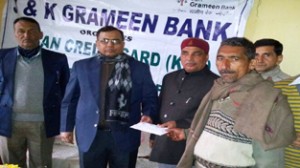 Vagish Chander,Chairman, J&K Grameen Bank presenting cheque to a beneficiary at Pallanwala on Tuesday.