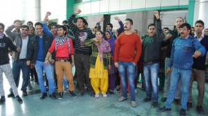 Para-medical staff and public holding a joint protest against PPP mode in Super Specialty Hospital Jammu on Thursday.