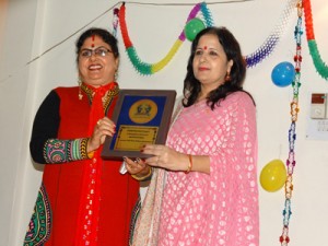 Sudha Joshi presenting memento to Sweety Raina at FHQ, Jammu on Wednesday.