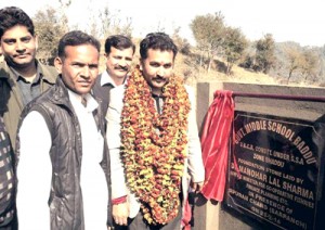 Minister of State for Fisheries Dr Manohar Lal Sharma laying foundation stone of school building at Kathua on Tuesday.