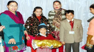 Student of Jodhamal School presenting gifts to a student of the village Ismailpur Kothe, Bishnah.