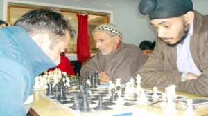 Players busy in making moves during Senior State A Chess Tournament in Jammu on Friday.