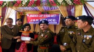 DIG Shakeel Ahmed Beig felicitating winner during awareness camp on road safety.