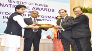 J K Sharma and A K Malhotra receiving gold shield from Jyotiraditya M Scindia at New Delhi on Tuesday.