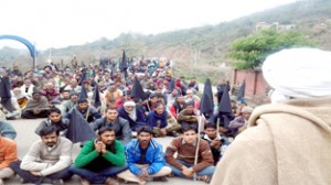 People sitting on dharna on Mansar-Udhampur road on Thursday.