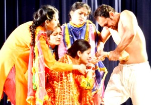 A scene from Balwant Thakur's Dogri play 'Ghumayee' presented by Natrang at General Zorawar Singh Auditorium, University of Jammu on Saturday.