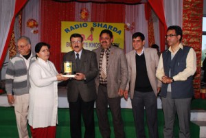 Speaker Legislative Assembly Mubarak Gul distributing memento to an artist at Jammu on Sunday.