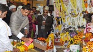 Minister for PHE, Sham Lal Sharma paying obeisance at Mathwar on Tuesday.