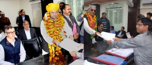 Congress candidate Madan Lal Sharma and his PDP rival Yash Pal Sharma filing nomination papers before the Returning Officer in Jammu on Thursday.       	      —Excelsior/Rakesh