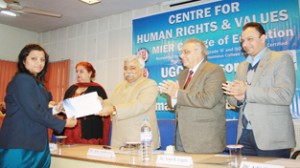 Ajay Sadhotra, Minister for Planning and Development, Labour and Employment distributing certificate at MIER College of Education. 