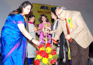 Dignitaries lighting the ceremonial lamp during annual day celebration at Apple Kids School in Jammu.