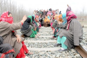 Villagers sitting on the rail track on Thursday. -Excelsior/ Younis Khaliq 