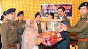DIG IRP, Vijay Singh Sambyal and others distributing assistance to a beneficiary at Jammu on Friday.
