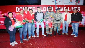 Organizers posing for a group photograph alongwith the chief guest during a blood donation camp organized by Vodafone and Red Cross Society in Jammu.