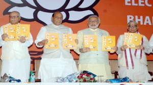 BJP president Rajnath Singh with senior party leaders L K Advani, Murli Manohar Joshi and party's Prime Ministerial candidate Narendra Modi releasing BJP Manifesto for the Lok Sabha elections -2014 in New Delhi on Monday. (UNI)