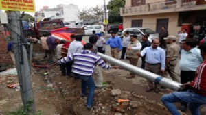 JMC Commissioner Kiran Wattal along with officers seizing equipment and material of private company which was laying cables without permission in Jammu.