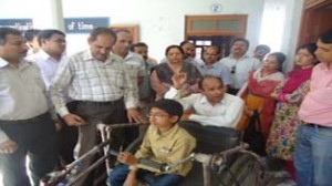 Dignitaries distributing tricycle to a beneficiary during a camp at Jammu on Saturday.