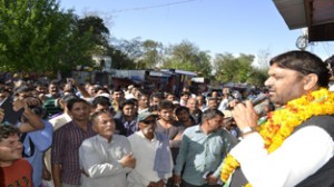 Congress candidate Madan Lal Sharma addressing public rally in Khour on Monday.