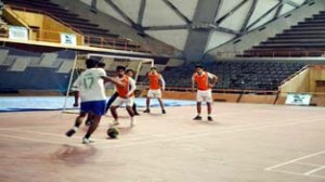 Footballers in action during a match at Sher-e-Kashmir Indoor Sports Hall in Srinagar.