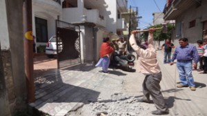 JMC officials demolishing unauthorized construction at Karan Nagar on Saturday.