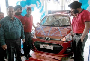 Officials of KC Hyundai and HMIL posing with new ‘Hyundai Xcent’, which was launched at showroom of KC Hyundai at Jammu on Thursday.     —Excelsior/Rakesh