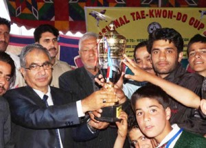 Minister for Agriculture Production, Ghulam Hassan Mir presenting trophy to winners of Taekwon-Do Championship.
