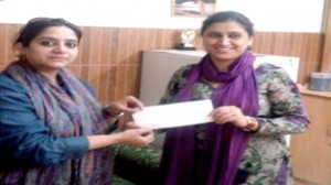 Principal of Jesus Care Convent School handing over donation cheque to HelpAge India Executive at Jammu.