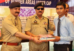 Shakeel Ahmed Beig, DIG Jammu-Samba-Kathua Range distributing books among needy students on Tuesday.