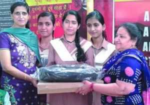 Laptops being awarded to meritorious students at SP Smart Higher Secondary School in Jammu. 