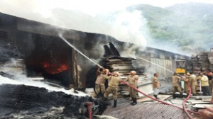 Fire fighters trying to control flames in scrap yard of Mata Vaishno Devi Shrine Board on Friday.