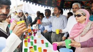 KU VC Prof AM Shah and others offering juice to devotees during a social service camp on Friday.