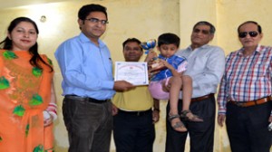 A student of Blind School being presented award & certificate during a function by Information Department at Jammu on Tuesday.