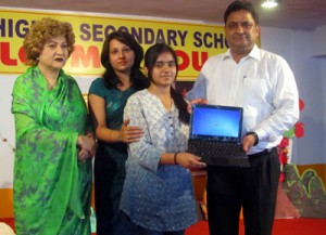 Kiran Wattal, Commissioner Jammu Municipality presenting Laptop to Alka Kumari at Tiny Tots School in Jammu.